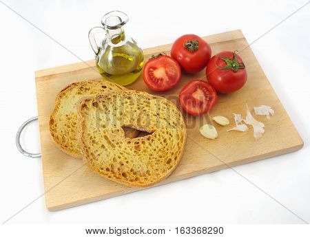 Italian food: friselle (dry bread), red tomato, oil and garlic.