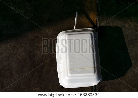 Disposable foam food box on the sidewalk