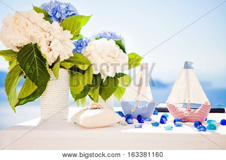 ships and a vase of flowers on the white table