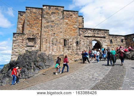 Edinburgh, United Kingdom - June 19, 2014. Foogs gate is the main entrance to the citadel of the Edinburgh castle. View of the gate with people.