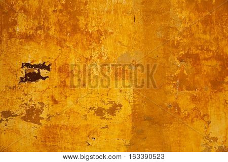 Empty space for text or image. Abstract background of yellow color. The texture of the concrete walls are painted in orange-yellow