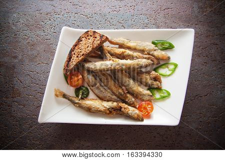 capelin fish fried in batter with sauce