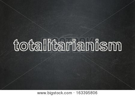 Political concept: text Totalitarianism on Black chalkboard background