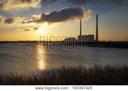 Beautifull landscape with thermal power plant lake and sunset sky.