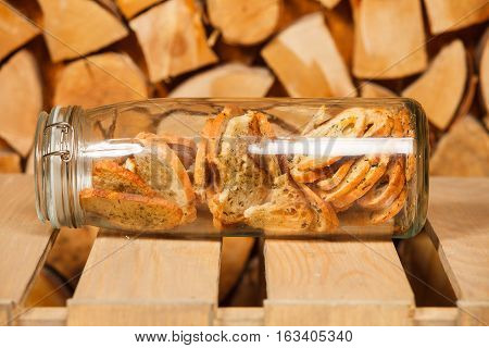 Crackers of white bread with spices in a glass jar
