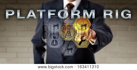 Male corporate executive is touching PLATFORM RIG on an interactive control screen highlighting virtual symbols. Oil and gas offshore drilling rig metaphor and field development management concept.