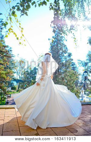 Bride spinning in white wedding dress on wedding