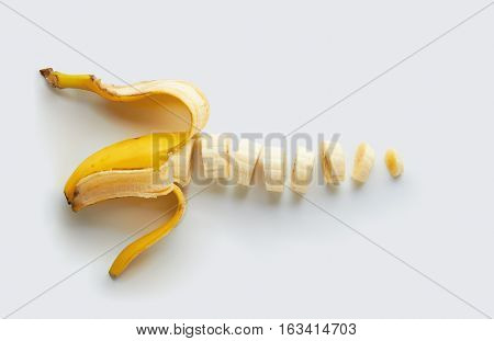Sliced banana with peel on a white background