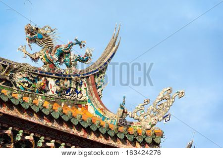Asia culture concept - Roof with beautiful decoration of famous heritage landmark the traditional old oriental Chinese temple lungshan in Taipei Taiwan