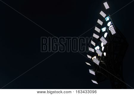 Lighting tower of stadium on the dark or night sky background.
