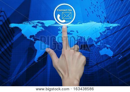 Hand pressing telephone and mail icon button over world map and city tower Customer support concept Elements of this image furnished by NASA