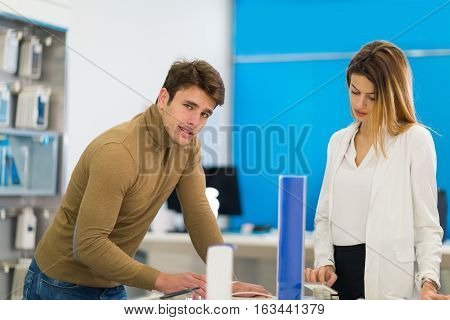 Two people are choosing smart phones in store