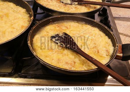 Three Large Pots With The Typical Italian Dish Called Frico