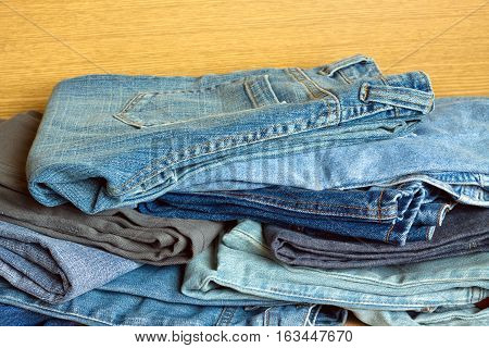 Heap of indigo jeans on sale. Front view close-up