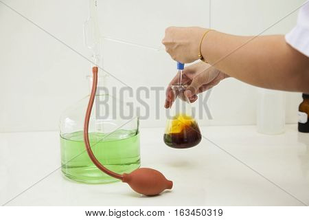 researcher working in a biotechnology lab / biochemical engineer working with microplate in a laboratory experiment