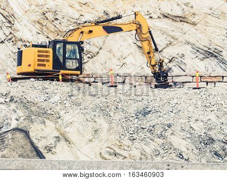 Industry. Heavy duty excavator machine digger bulldozer working on stone construction site Norway Scandinavia