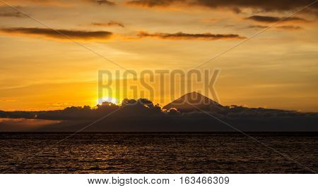 Sunset landscape with panoramic view to Bali and Agung Volcano mountain taken from Lombok Island Indonesia
