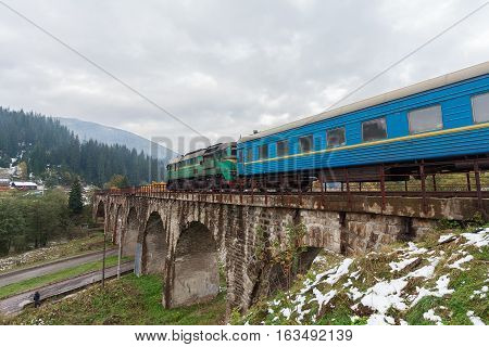 Diesel train traveling on the viaduct. Vorokhta Ukraine