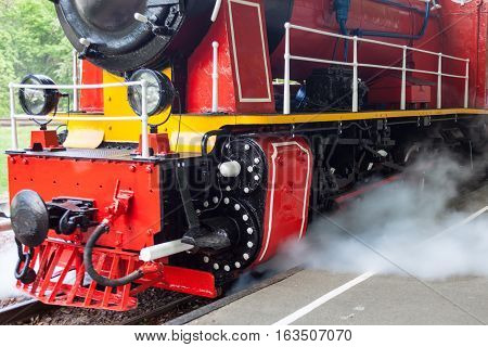 Steam locomotive blowing off the steam before moving