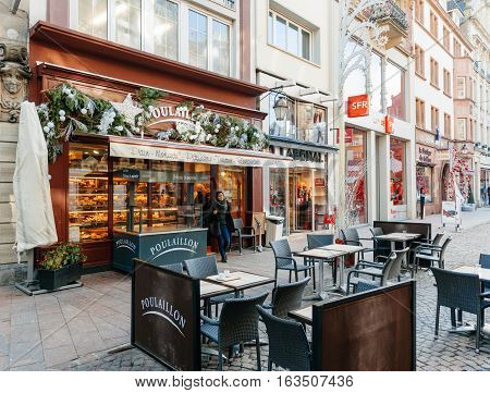 STRASBOURG FRANCE - DEC 12 2015: Poulaillon Artisan Boulanger bakery in French city with customers and outdoor terrace