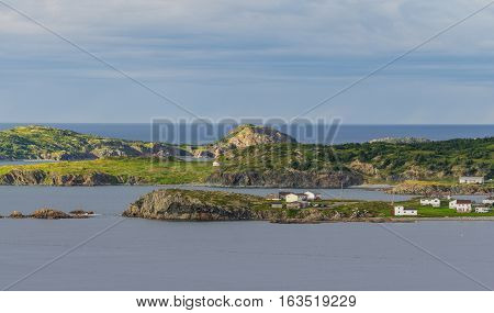 Small village community in Twillingate, Newfoundland.  Homes along shoreline in coastal village, dwarfed by their surroundings along the Island's edges.