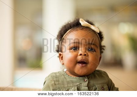 African American baby girl laughing and smiling.