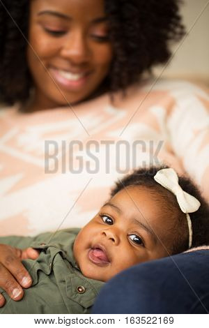 Happy African American mother and daughter playing.
