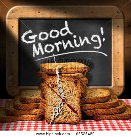 Rusks of wholemeal flour on a table with a clock made with a rusk and a blackboard with text Good morning!