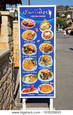 BALI, CRETE - SEPTEMBER 16, 2016 - Greek and international menus painted outside a restaurant Bali Crete Greece Europe, September 16, 2016.