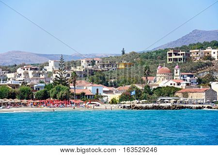 KALYVES, CRETE - SEPTEMBER 16, 2016 - View across the Aegean sea towards the beach and church Kalyves Crete Greece Europe., September 16, 2016.