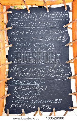 KALYVES, CRETE - SEPTEMBER 16, 2016 - Greek Taverna menu chalkboard showing traditional and international dishes Kalyves Crete Greece Europe, September 16, 2016.
