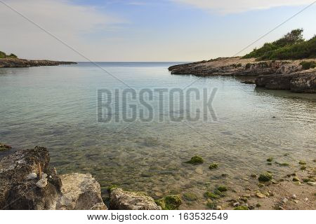 Salento coast: Porto Selvaggio Bay.ITALY (Apulia).Unspoiled nature with a small beach of sand and pebbles, surrounded by a rocky coastline.
