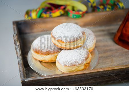 doughnut on tablet with air snake and colorful hat