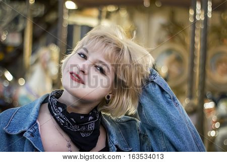 Bucolic portrait of beautiful girl over carousel background
