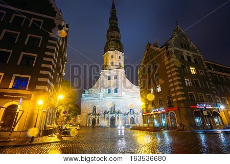 Riga Latvia - July 3 2016: Night View Of St. Peter's Church In Old Town Riga Latvia. Illuminated Street.