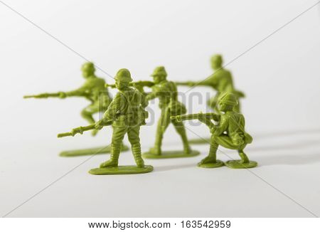 Green plastic toy soldiers on a white background