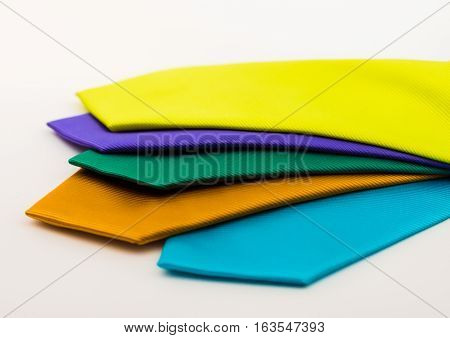 multi colored ties on a white background