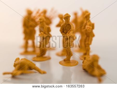 Small plastic toy soldiers on white background