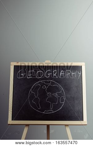 Geography Lesson On Blackboard Or Chalkboard. Written In White Chalk
