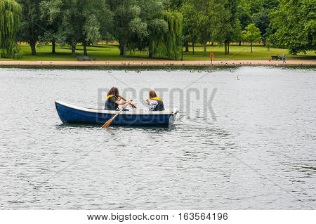 Rowing a small boat on The Serpentine, Hyde Park, England