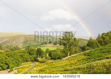 Rainbow landscape near Pooley Bridge, in the Ullswater area of the Lake District in England.