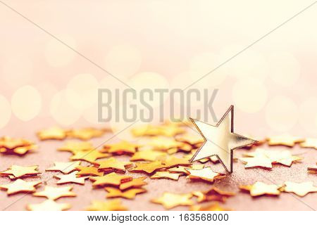 Holiday golden star on table blurred light effect selective focus