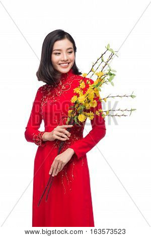 Portrait Of A Beautiful Asian Woman On Traditional Festival Costume Ao Dai Holding Hoa Mai Tree (och