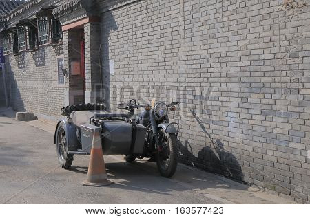BEIJING CHINA - OCTOBER 26, 2016: Old army motorbike parked in Houhai lake Futong street.