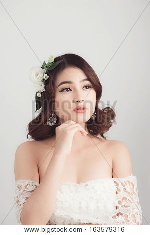 Beautiful asian woman bride on grey background