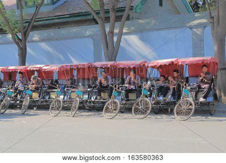 BEIJING CHINA - OCTOBER 26, 2016: Rickshaw drivers wait for passengers in Houhai lake Futong street.