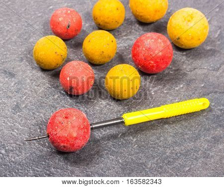 Carp Hook Boilies on black background .