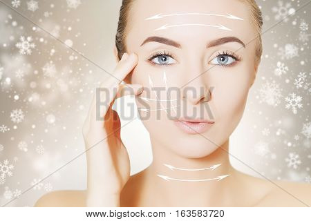 beautiful young woman face with lifting marks for surgeon