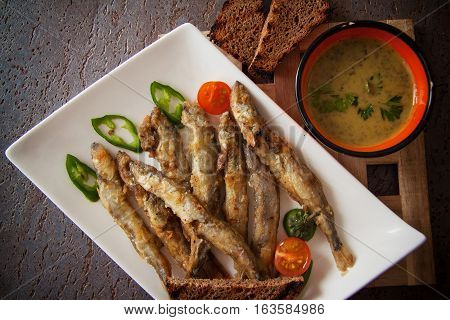 capelin fish fried in batter with sauce