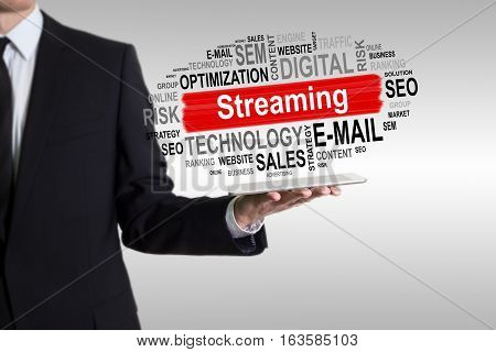 Streaming concept. Man holding a tablet computer.